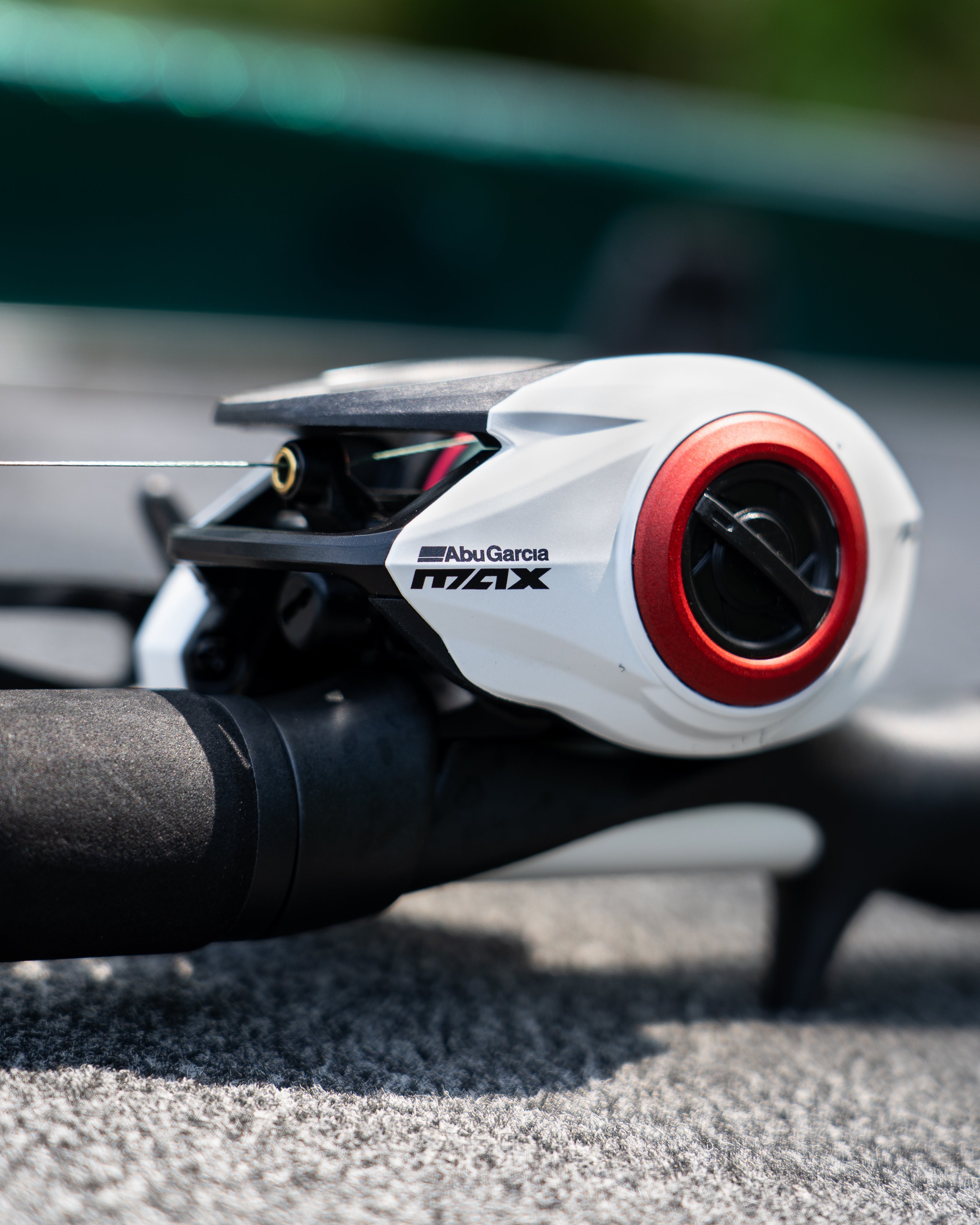 Close-up of Abu Garcia Max reel on a fishing rod with blurred background
